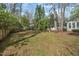 Spacious backyard with mature trees, offering privacy and room for recreation at 303 Granville Rd, Chapel Hill, NC 27514