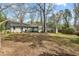 Picture of the backyard of the property with plenty of mature trees at 303 Granville Rd, Chapel Hill, NC 27514