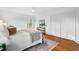 Bedroom features hardwood floors, neutral decor, and a closet with paneled doors at 303 Granville Rd, Chapel Hill, NC 27514