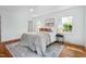 Well-lit bedroom with neutral decor, hardwood floors, an area rug, and multiple windows at 303 Granville Rd, Chapel Hill, NC 27514