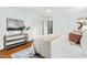 Bedroom features hardwood floors, neutral decor, a white ceiling fan, and a closet with paneled doors at 303 Granville Rd, Chapel Hill, NC 27514