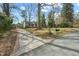 Charming home with brick accents, a paved driveway, and a detached garage, showcasing curb appeal at 303 Granville Rd, Chapel Hill, NC 27514