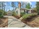 Side view of home, showing the driveway to a detached garage and the front entrance at 303 Granville Rd, Chapel Hill, NC 27514