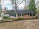 Charming single-story home with brick accents, a well-manicured lawn, and inviting curb appeal at 303 Granville Rd, Chapel Hill, NC 27514