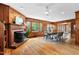 Bright living room with a fireplace and mantle plus hardwood floors and light fixtures at 303 Granville Rd, Chapel Hill, NC 27514
