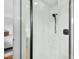 Modern shower with a black shower head and glass door at 303 Granville Rd, Chapel Hill, NC 27514