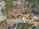 An aerial view captures a charming two-story home with a well-manicured lawn in a lush, wooded neighborhood at 330 Bridgeport Cir, Clayton, NC 27527
