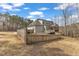 Large fenced in backyard with deck, sunroom, trampoline, and basketball hoop at 330 Bridgeport Cir, Clayton, NC 27527