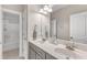 A bright bathroom featuring double vanity with open doorway and natural light at 330 Bridgeport Cir, Clayton, NC 27527