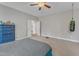 Spacious bedroom featuring a ceiling fan, neutral colors, and open doorway at 330 Bridgeport Cir, Clayton, NC 27527