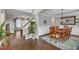 Elegant dining area with hardwood floors, a wooden table set for six, and an arched entryway at 330 Bridgeport Cir, Clayton, NC 27527