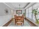 Bright dining room featuring a decorative rug, tray ceiling, and pendant lighting fixture at 330 Bridgeport Cir, Clayton, NC 27527