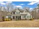 Beautiful two-story home featuring stone accents, complemented by a well-maintained lawn and lush landscaping at 330 Bridgeport Cir, Clayton, NC 27527