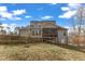 Large home with deck and sunroom extension overlooks backyard with wood fence at 330 Bridgeport Cir, Clayton, NC 27527