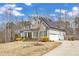 Lovely home with solar panels, featuring a long driveway, beautiful landscaping, and a well-maintained front yard at 330 Bridgeport Cir, Clayton, NC 27527