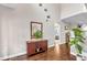 Bright foyer featuring hardwood floors, a decorative cabinet, a stylish mirror, and an arched doorway at 330 Bridgeport Cir, Clayton, NC 27527