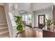 Grand foyer with hardwood floors, an elegant staircase, and an arched entryway leading to the dining area at 330 Bridgeport Cir, Clayton, NC 27527