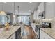 Modern kitchen featuring a granite island, stainless steel appliances, and bright white cabinets at 330 Bridgeport Cir, Clayton, NC 27527