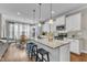 Modern kitchen with granite countertops, white cabinets, and stainless steel appliances at 330 Bridgeport Cir, Clayton, NC 27527