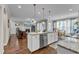 Open-concept kitchen with white cabinets, stainless steel appliances, and granite countertops at 330 Bridgeport Cir, Clayton, NC 27527