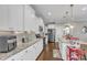 A kitchen with white cabinetry, granite countertops and backsplash, stainless steel appliances, and a center island at 330 Bridgeport Cir, Clayton, NC 27527