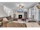 Comfortable living room with fireplace, TV, lots of natural light and cozy sectional sofa at 330 Bridgeport Cir, Clayton, NC 27527