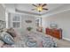 A primary bedroom featuring a large bed, dresser, and natural light from the windows at 330 Bridgeport Cir, Clayton, NC 27527