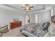 A primary bedroom showcases a large bed, dresser, and views through several windows at 330 Bridgeport Cir, Clayton, NC 27527