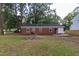 An exterior view of the back of the home with backyard at 3429 Dogwood Dr, Raleigh, NC 27604