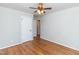 Bedroom with hardwood floors, a ceiling fan, and a view to an adjacent room at 3429 Dogwood Dr, Raleigh, NC 27604