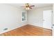 Bedroom showcasing hardwood floors, a ceiling fan, and natural light from a window at 3429 Dogwood Dr, Raleigh, NC 27604
