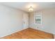 Bright bedroom with neutral walls, wood floors, and a large window at 3429 Dogwood Dr, Raleigh, NC 27604