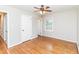 Bedroom with hardwood floors, a ceiling fan and a closet visible near an open doorway at 3429 Dogwood Dr, Raleigh, NC 27604
