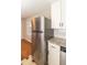 Kitchen featuring stainless steel refrigerator and sleek white cabinetry at 3429 Dogwood Dr, Raleigh, NC 27604