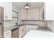 Updated kitchen with stainless steel appliances, white cabinets, and granite counters at 3429 Dogwood Dr, Raleigh, NC 27604