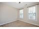 Bedroom with two windows providing natural light and neutral carpet at 345 Springtime Fields Ln, Wake Forest, NC 27587