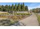 Community entrance showing a stone sign, landscaping, and flower beds at 345 Springtime Fields Ln, Wake Forest, NC 27587
