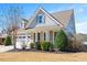 Well-maintained home showcasing manicured landscaping, stylish siding, and welcoming front porch at 345 Springtime Fields Ln, Wake Forest, NC 27587