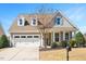 Beautiful home featuring a two-car garage, dormers, stone accents and a well-manicured yard at 345 Springtime Fields Ln, Wake Forest, NC 27587