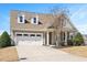 Charming home featuring a two-car garage, dormers, and manicured front yard landscaping at 345 Springtime Fields Ln, Wake Forest, NC 27587