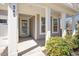 Inviting covered front porch with white columns and glass front door enhances curb appeal at 345 Springtime Fields Ln, Wake Forest, NC 27587