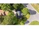 Aerial view of a home with dark roof surrounded by trees at 3624 Singleleaf Ln, Raleigh, NC 27616