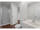 Bathroom features a white sink vanity, toilet, and shower with glass doors and wood look floors at 3624 Singleleaf Ln, Raleigh, NC 27616