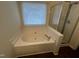 A luxurious bathroom featuring a corner whirlpool tub and glass-enclosed shower at 3624 Singleleaf Ln, Raleigh, NC 27616