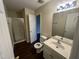 Bathroom with a shower, vinyl flooring, vanity, and white fixtures at 3624 Singleleaf Ln, Raleigh, NC 27616