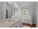 Bright bathroom with double vanity, soaking tub and separate shower at 3624 Singleleaf Ln, Raleigh, NC 27616