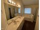 Bathroom with double vanity, large mirror, and separate tub and shower at 3624 Singleleaf Ln, Raleigh, NC 27616