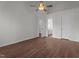 Bedroom features ceiling fan, wood look floors, and natural light from two windows at 3624 Singleleaf Ln, Raleigh, NC 27616