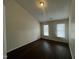 Bedroom with hardwood floors, two windows, and neutral wall color at 3624 Singleleaf Ln, Raleigh, NC 27616