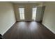 Bedroom featuring wood-look vinyl flooring, bright natural lighting, and a neutral color palette at 3624 Singleleaf Ln, Raleigh, NC 27616
